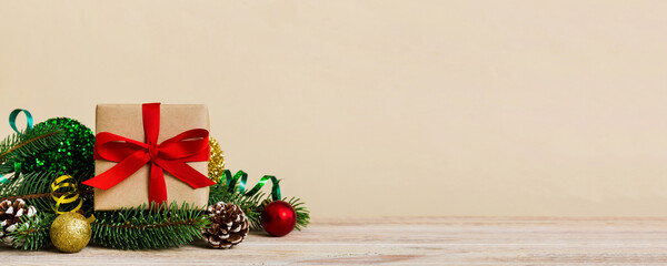 New Year Christmas mood, gift box, branches of a christmas tree, New Year decorations on a colored background