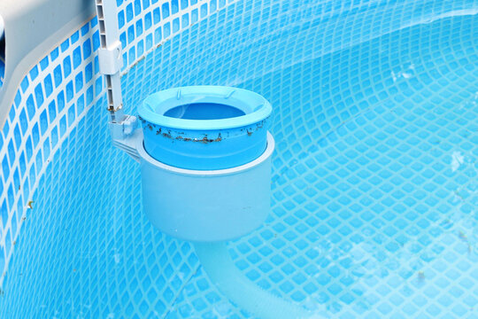 Top view of the blue skimmer for cleaning the pool in clear water. Contaminated pool cleaning concept