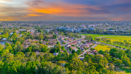 Obraz premium Aerial Panorama Drone View of a inner western Sydney Suburb of Ashbury Urban Sprawl and the terracotta roof tops streets and trees of Suburban Sydney NSW Australia