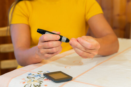 Female hands testing blood sugar with glucometer