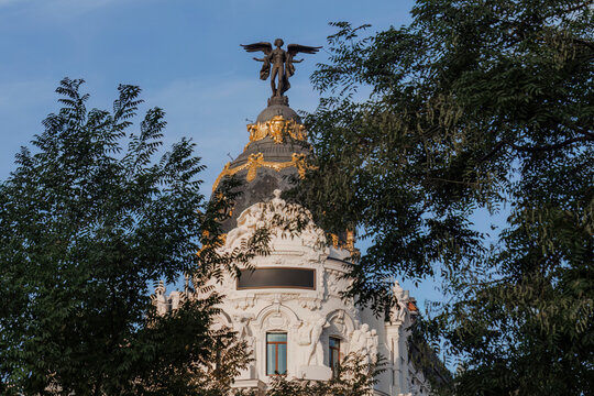 Metropolis building dome adorned with sculpture and foliage