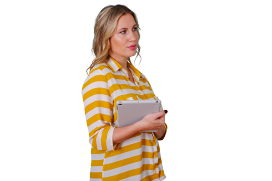 Blonde woman wearing striped shirt holding tablet, looking away, exploring new ideas, digital communication