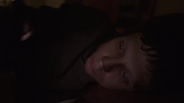 Man addicted to smartphone at night, social media dependence, compulsive scrolling