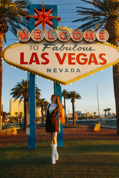 Iconic Las Vegas welcome sign at sunset with tourist