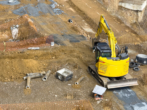 Yellow bulldozer on construction site in urban area