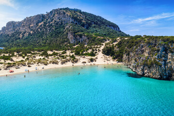Aerial view of the popular Voidokilia beach in Messinia, Greece, with the old castle on top pf the mountain, sand dunes and turquoise sea