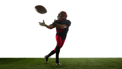 Football player catching descending ball with concentrated emotion. Concept of skill training, body in motion, coaching slides, sport education, app mockups, advertising layouts.