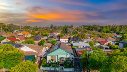 Obraz premium Aerial Panorama Drone View of a inner western Sydney Suburb of Ashbury Urban Sprawl and the terracotta roof tops streets and trees of Suburban Sydney NSW Australia