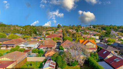 Fototapeta premium Aerial Panorama Drone View of a inner western Sydney Suburb of Ashbury Urban Sprawl and the terracotta roof tops streets and trees of Suburban Sydney NSW Australia