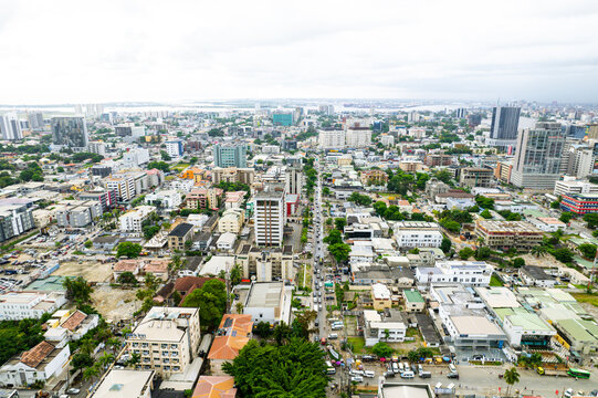 Aerial view of a vibrant cityscape revealing a tapestry of buildings and streets under a soft, diffused sky, Lagos, Lagos, Nigeria.