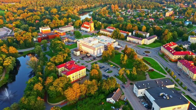 Bright sunset over Valmiera city center with river, park, and St, Simon's church