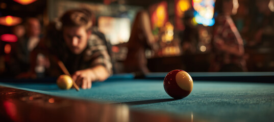 A man lines up his shot at a pool table in a bustling bar. The focus is on the cue ball. The player and bar patrons softly blurred in the background