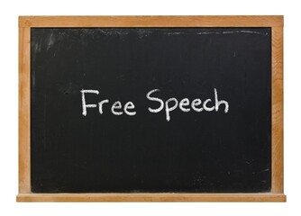 Free speech written in white chalk on a black chalkboard isolated in a wooden frame
