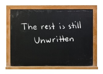 The rest is still unwritten written in white chalk on a black chalkboard isolated in a wooden frame