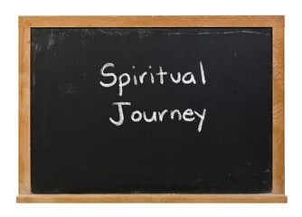 Spiritual journey written in white chalk on a black chalkboard isolated in a wooden frame