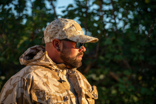 Camouflaged man in airsoft gear during outdoor play