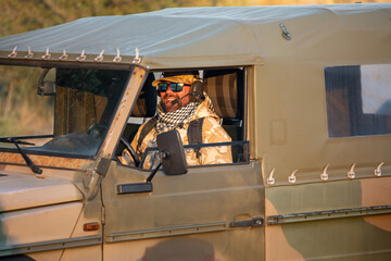 Camouflage man driving military vehicle for airsoft game