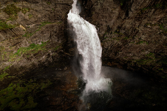 Aerial view of white water cascade roaring down the rugged, dark cliffs, a powerful display of nature's force, Dirdal, Rogaland, Norway.