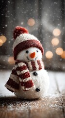 Cute christmas snowman on snowy wooden table with bokeh