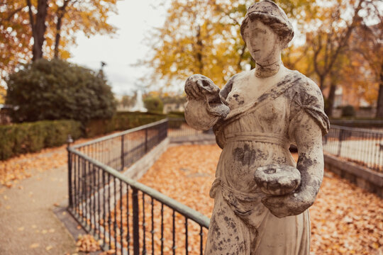 Autumnal statue in a classic garden