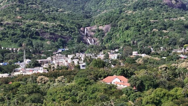 Aerial view of Courtallam, Tamil Nadu, showing waterfalls, temples, and lush greenery at the foothills of the Western Ghats, a popular ecotourism destination.