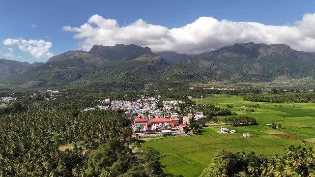Aerial view of a serene South Indian hill station, showcasing temples, lush greenery, and the tranquil beauty of the Western Ghats.