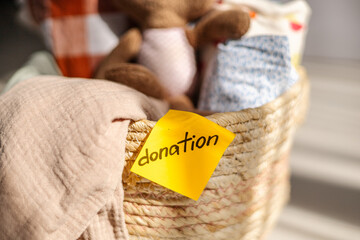 Wicker basket with donation label and soft items
