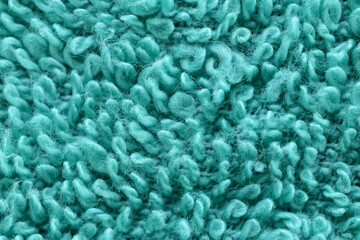 Textured pattern created with green terry cloth.