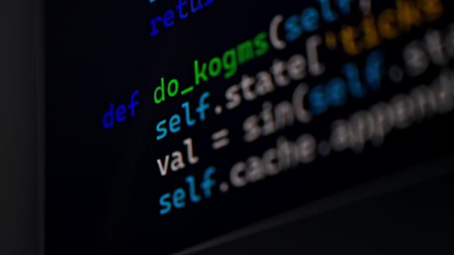 Closeup view of a computer monitor showing programming code on a dark background as someone types. Focus on screen details and syntax lines. - Powered by Adobe