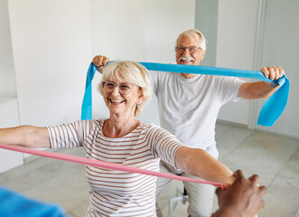 therapist senior man exercise exercising patient physical woman girl therapy care nurse recovery physiotherapy fitness stretching couple stretch band elderly support training