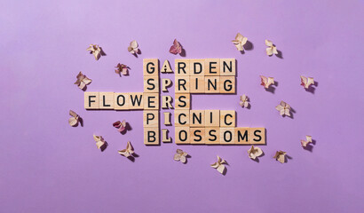 Crossword puzzle with wooden blocks and flowers