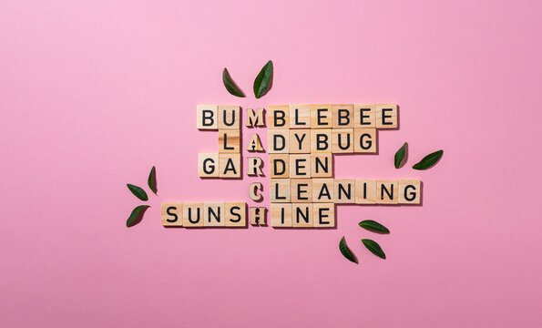 Wooden crossword puzzle on a pink background