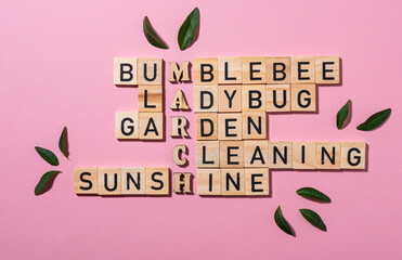 Wooden crossword puzzle on pink background