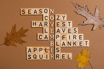 Crossword puzzle made with wooden blocks and leaves