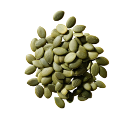 A pile of raw, hulled pumpkin seeds on a black background