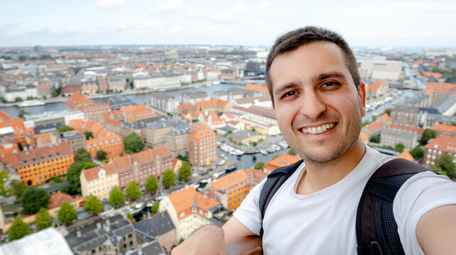 Man taking selfie atop Church of Our Saviour in Copenhagen