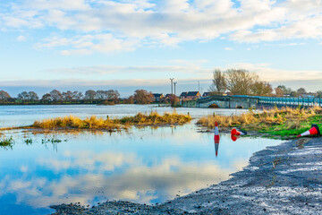 Flooding of agricultural fields at Bubwith near Selby,  East Yorkshire with flood water almost reaching the arches of Derwent Bridge and floating traffic cones. Copy space
