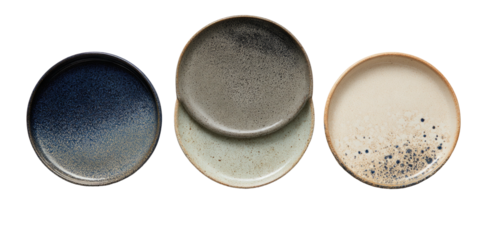 Three speckled ceramic plates in varying earthy tones
