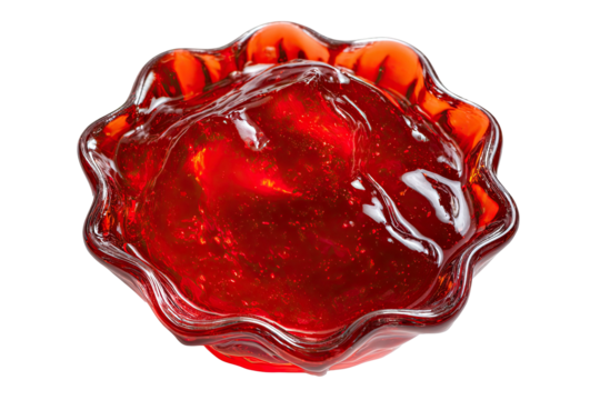 A close-up overhead shot of bright red, glistening jelly in a ruffled glass bowl