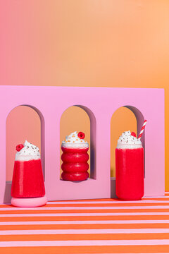 Raspberry smoothies with whipped cream toppings