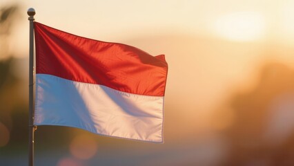 Indonesian flag Merah Putih with soft bokeh background at sunset