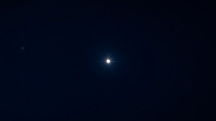 astrophotography. A single bright star shining intensely in a dark night sky with deep blue tones. travel magazines, destination branding, designed for travel destination branding.