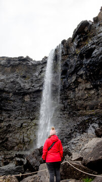 Person viewing the majestic Fossa waterfall on Streymoy