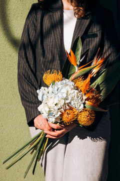 Woman holding exotic flower bouquet in shop