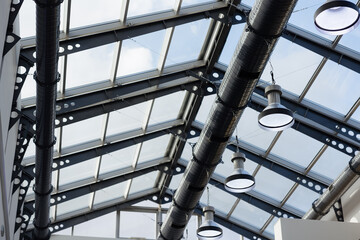 Modern industrial ceiling design with glass panels and sleek lighting fixtures