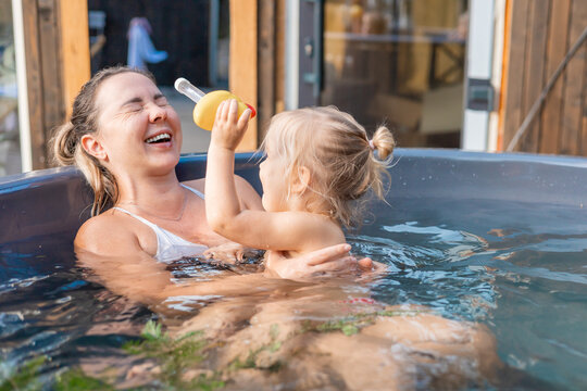 Mother and child enjoying relaxation in hot tub