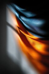 Abstract composition of orange and navy blue fabric folds with soft lighting