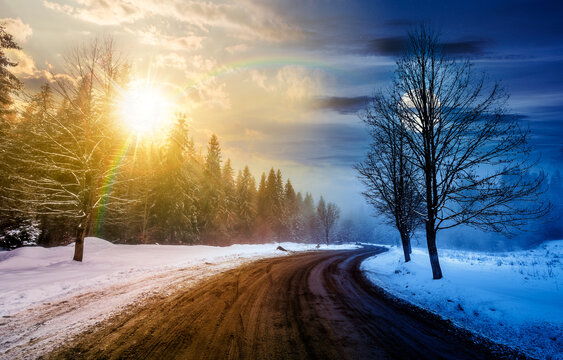 winding road through winter forest. day and night time change concept. beautiful nature scenery with naked trees on foggy weather with sun and moon at twilight. duality and transition template