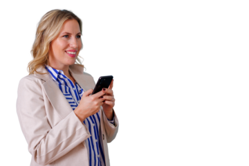 Businesswoman standing and smiling, using mobile phone for texting or browsing, transparent background