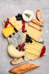 Italian and French gourmet cheese platter with craft cheese assortment on a marble platter. hard cheeses, mold cheese, gorgonzola, pecorino, Emmental, Roquefort cheddar